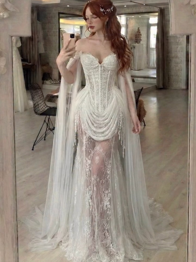 Romantic Transparent Lace Mermaid Wedding Gown Featuring Beaded Drape And Long Floating Tulle Cape Sleeves